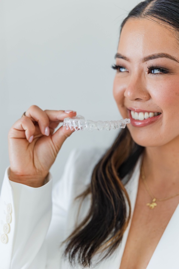 Atlee Family Dentistry Ashland, VA Dr. Alice with an Invisalign aligner (placeholder — replace with sleek-hair shot)