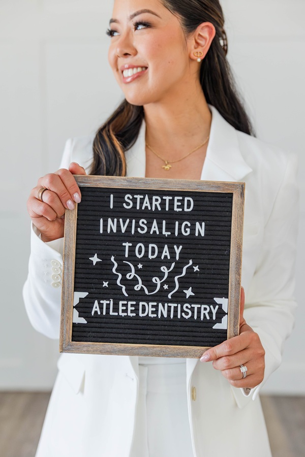 Atlee Family Dentistry Ashland, VA Dr. Alice holding an "I Started Invisalign Today" letter-board sign