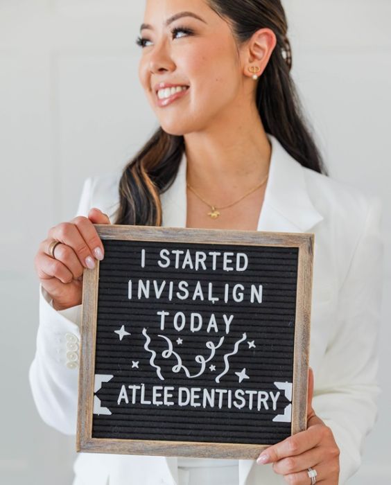 Atlee Family Dentistry Ashland, VA Dr. Alice holding an "I Started Invisalign Today" letter-board sign